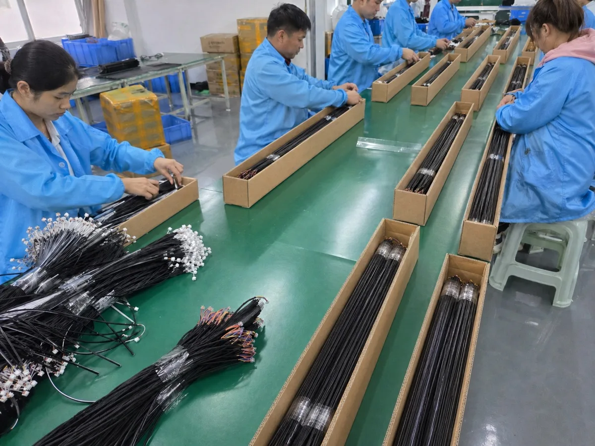 Real production area with operators packing completed lighting wiring assemblies