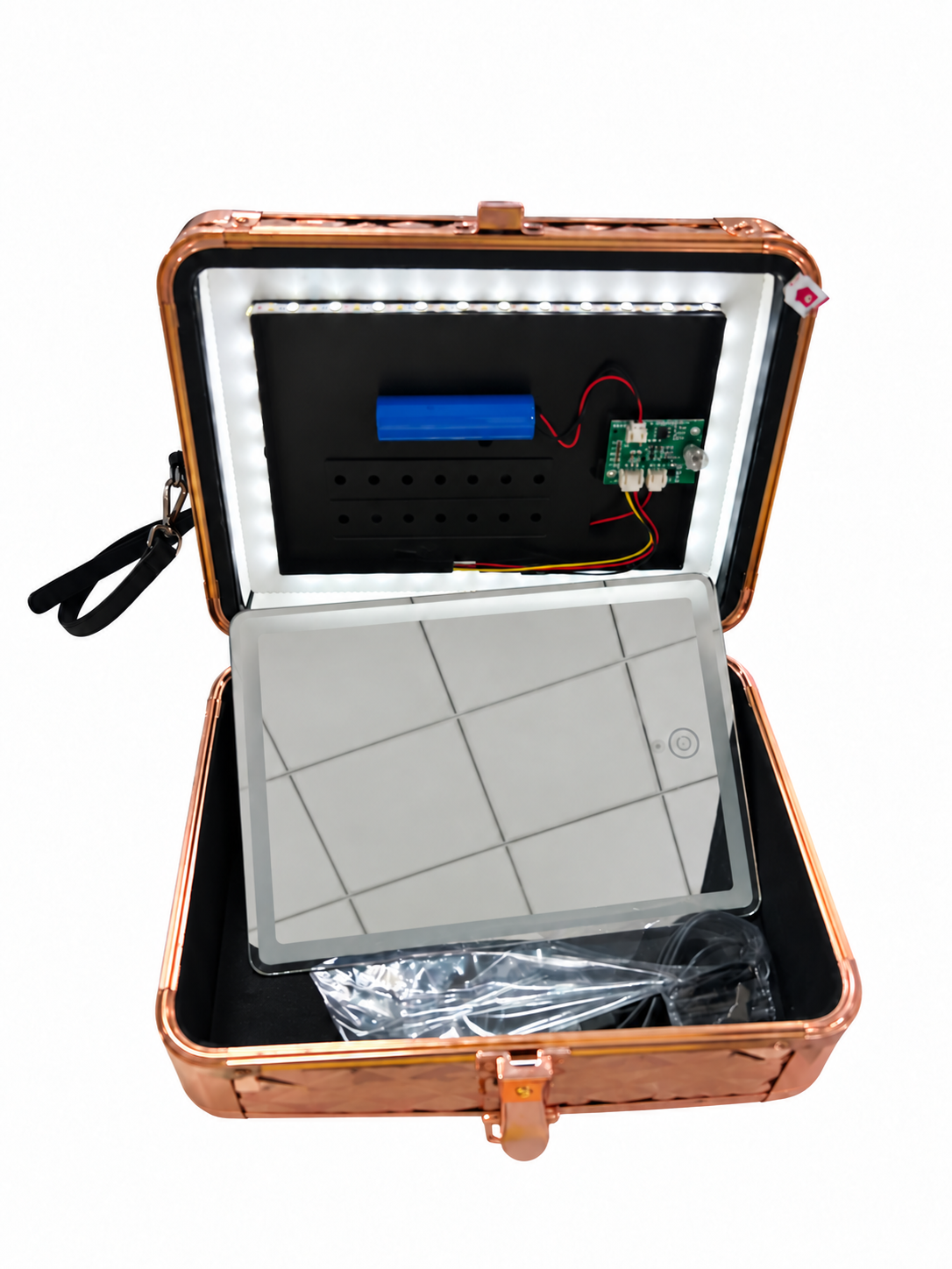 Open illuminated makeup case on a white background showing perimeter LEDs, a battery, a circuit board and internal wiring