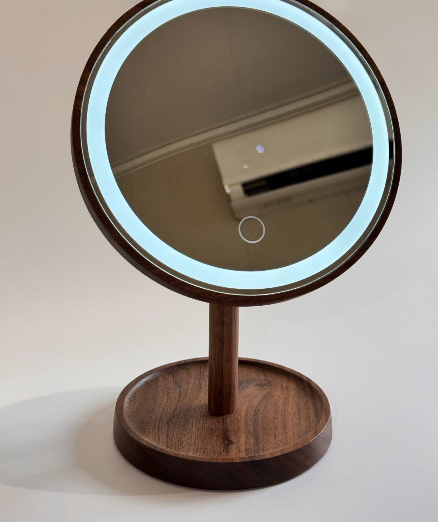 Illuminated tabletop vanity mirror with a light ring and circular touch marking
