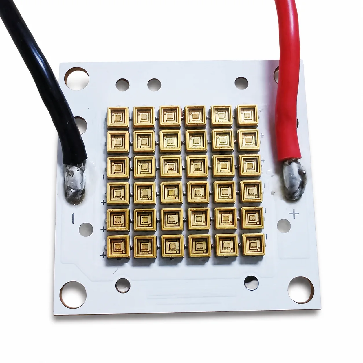 Square custom ultraviolet LED array module with power leads on a white background