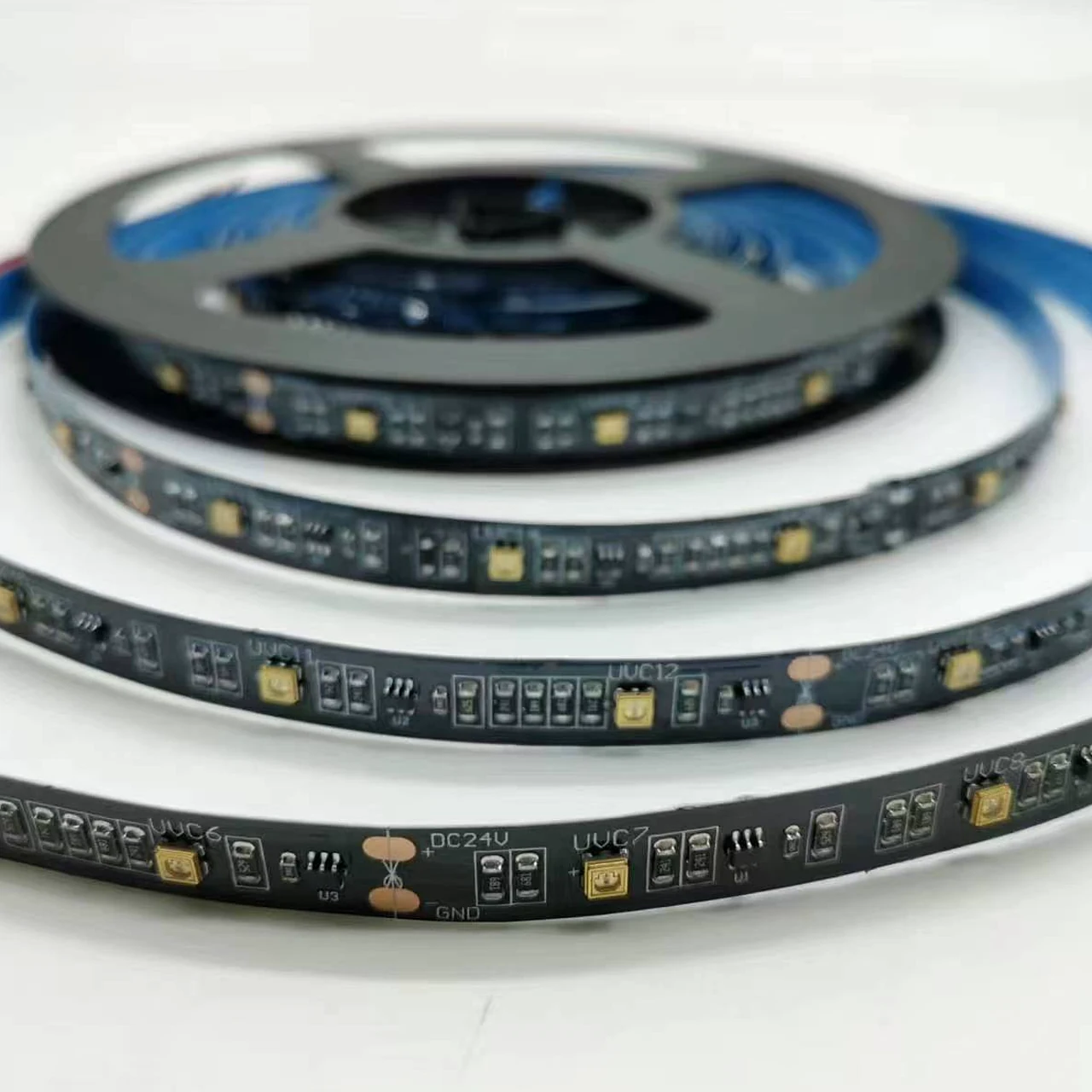 Close view of a black flexible ultraviolet LED strip with a visible DC24V board marking