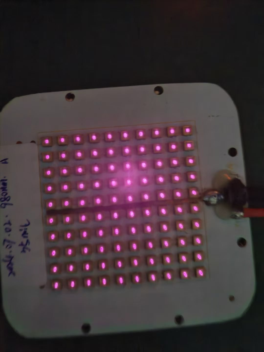 Planar emitter array photographed during a powered bench test
